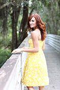 lifestyle model in yellow dress looking back while walking