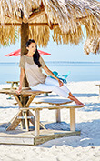 lifestyle model resting below an umbrella